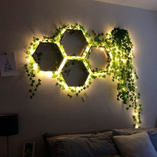 Hexagonal mirror framed with greenery and lights